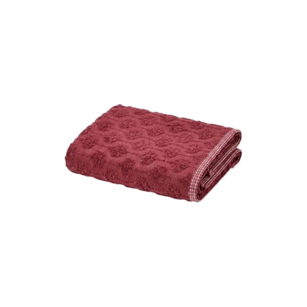 Serviette invitée Néroli en coloris prune, en éponge jacquard ciselée.
