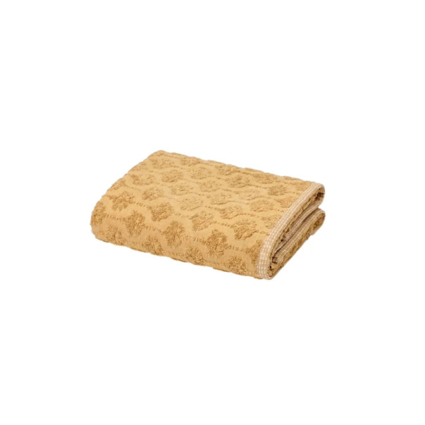 Serviette invitée Néroli en coloris curry, avec motif végétal en relief.